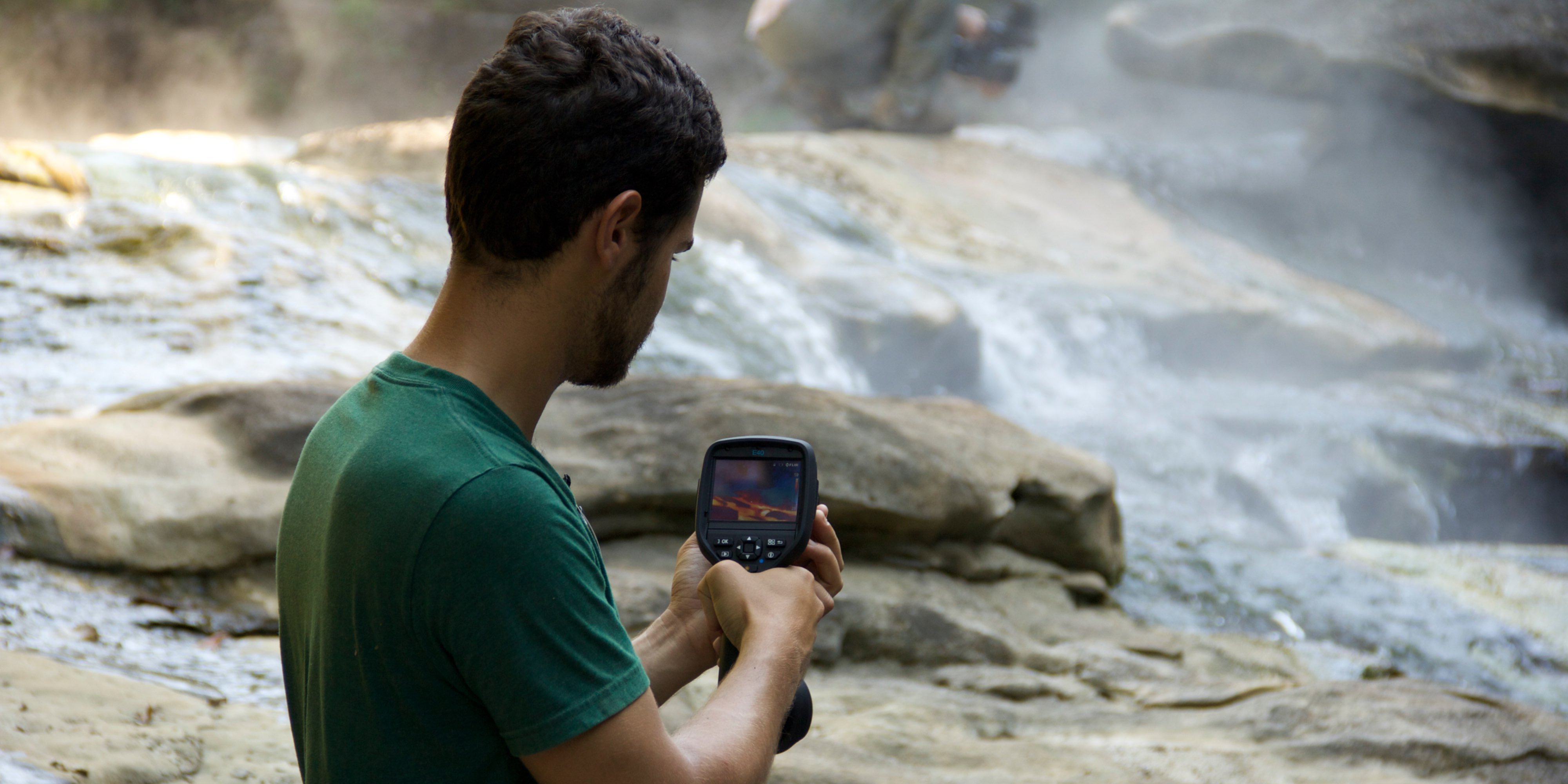 Andrés Ruzo using a thermal camera at the boiling river